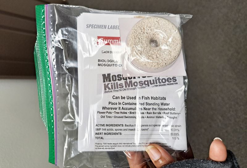 A baggie containing a mosquito dunk and an information sheet