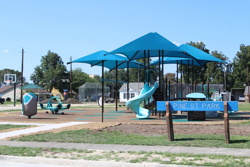 Pine Street park playground featuring new large play structure and smaller structures