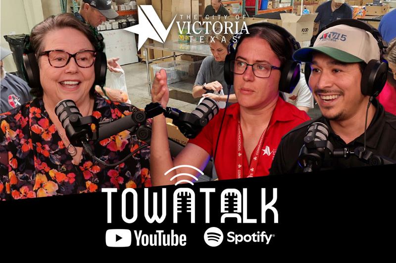 Food Bank CEO Robin Cadle, Sam Hankins and AJ Gonzales talking with a food bank background