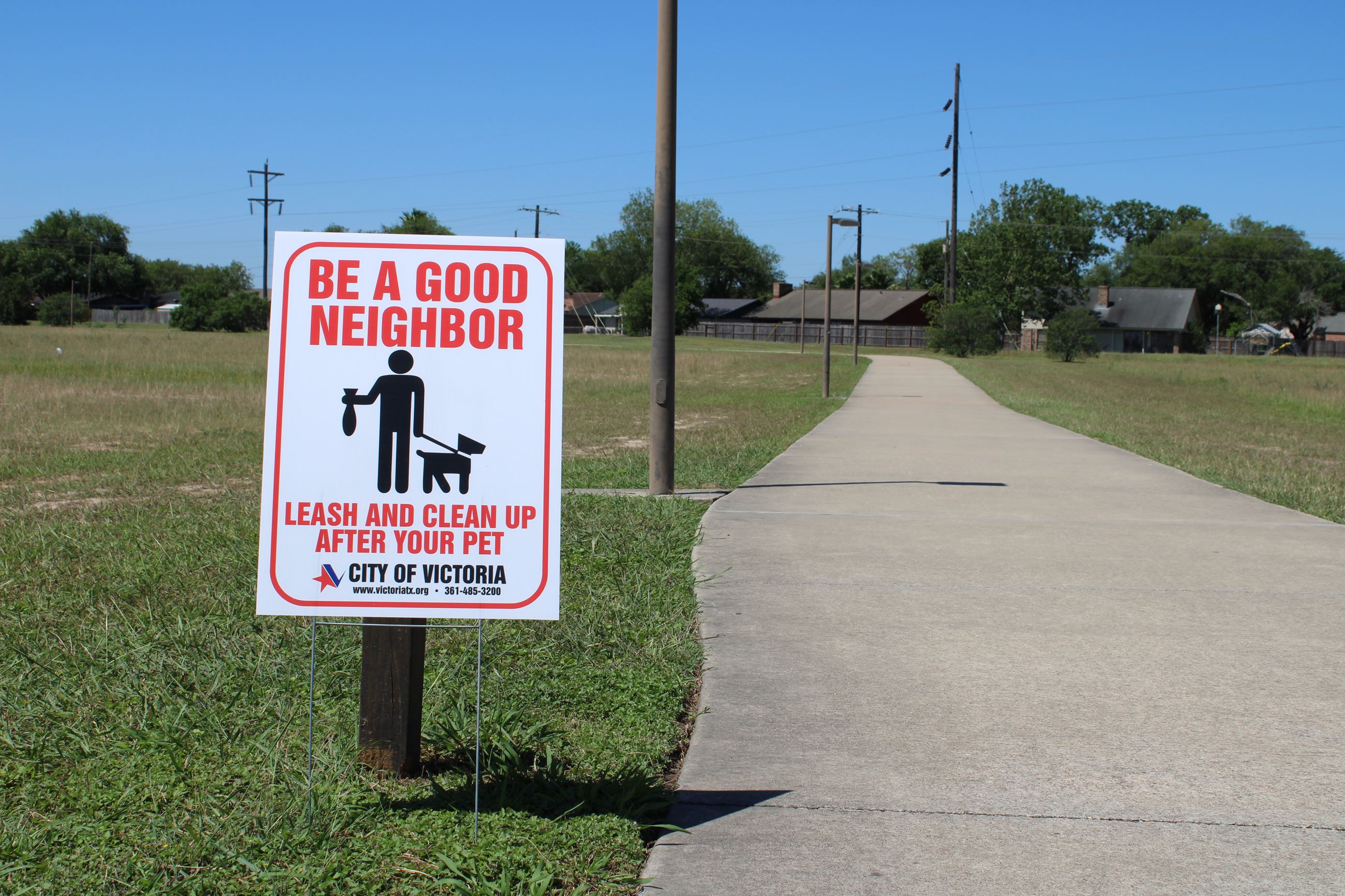 Pick up after your pets sign at walking trail