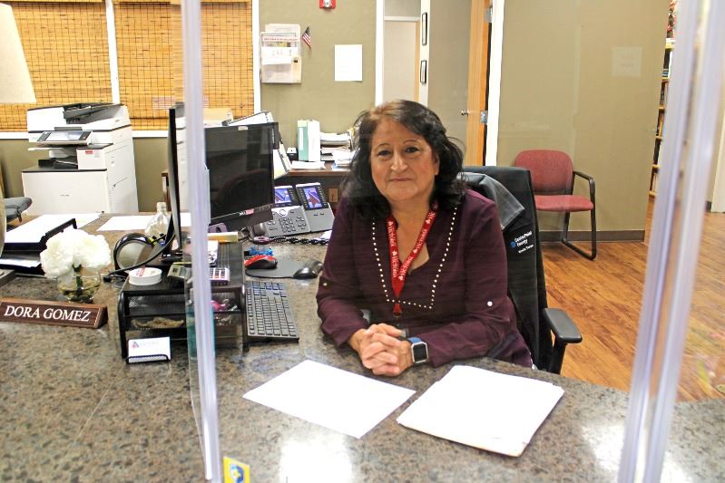 Development specialist Dora Gomez works at the front desk