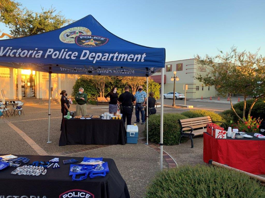 Police and residents mingle near a Victoria Police Department booth in the City Hall courtyard.