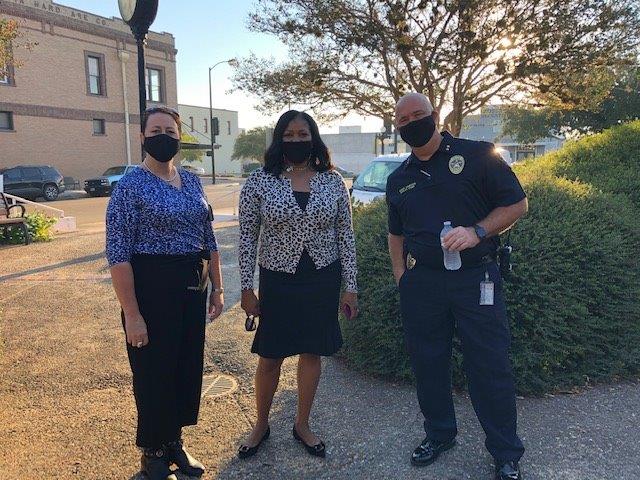 A police officer poses for a photo with members of the public at the City Hall courtyard.