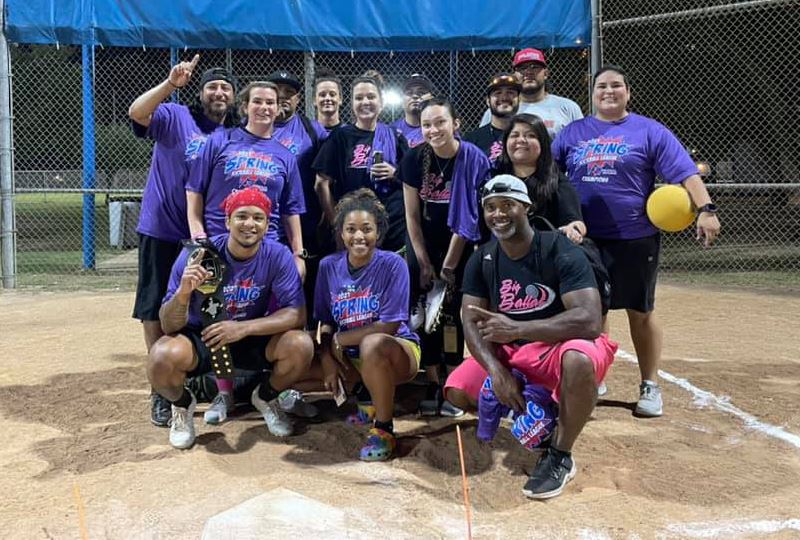 Group photo on kickball field. One player holds a kickball.