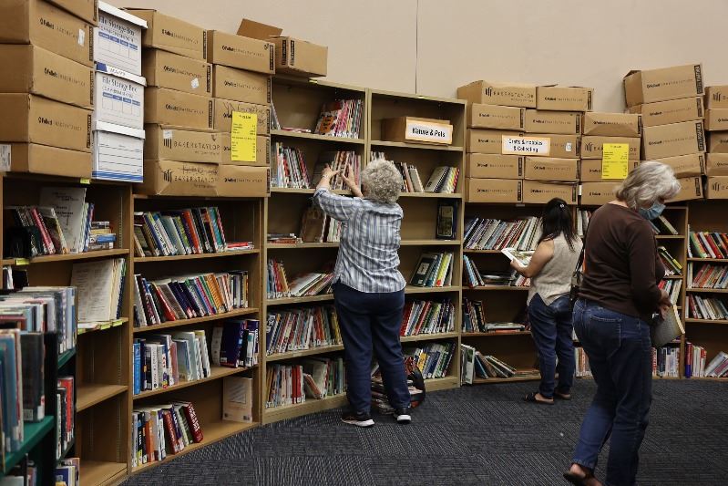 Patrons browse bookshelves in the library's Bronte Room