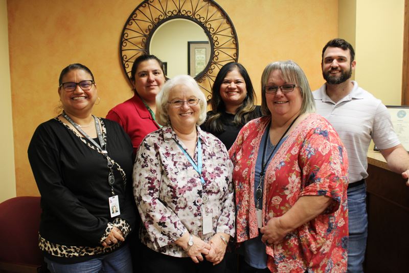 Group photo of six people in the lobby of the Finance office.