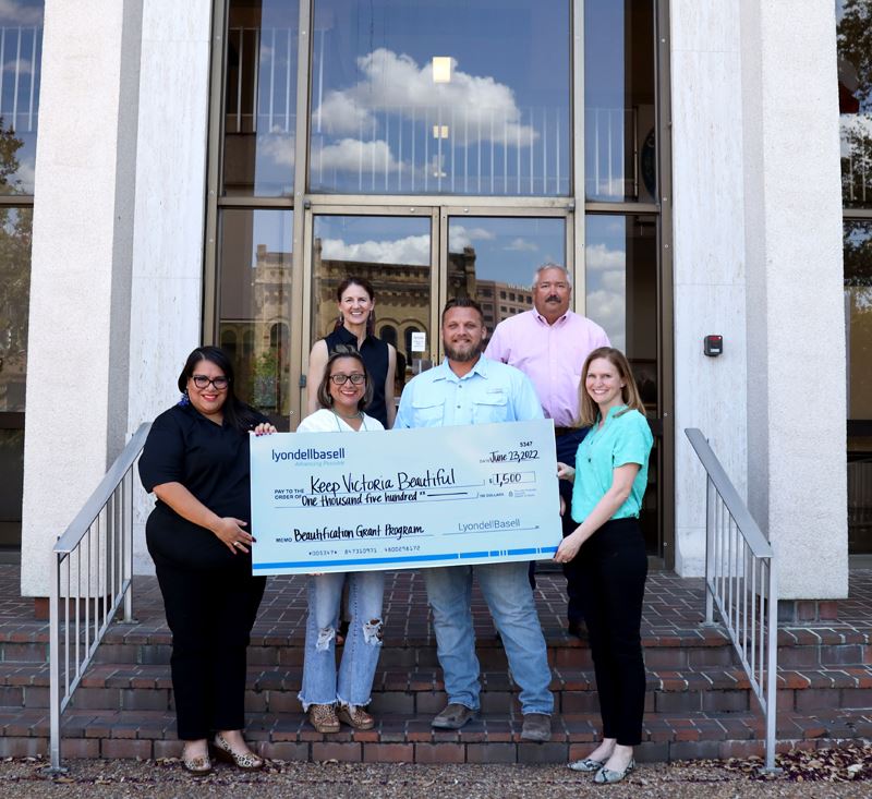 Group photo with giant check in front of City Hall
