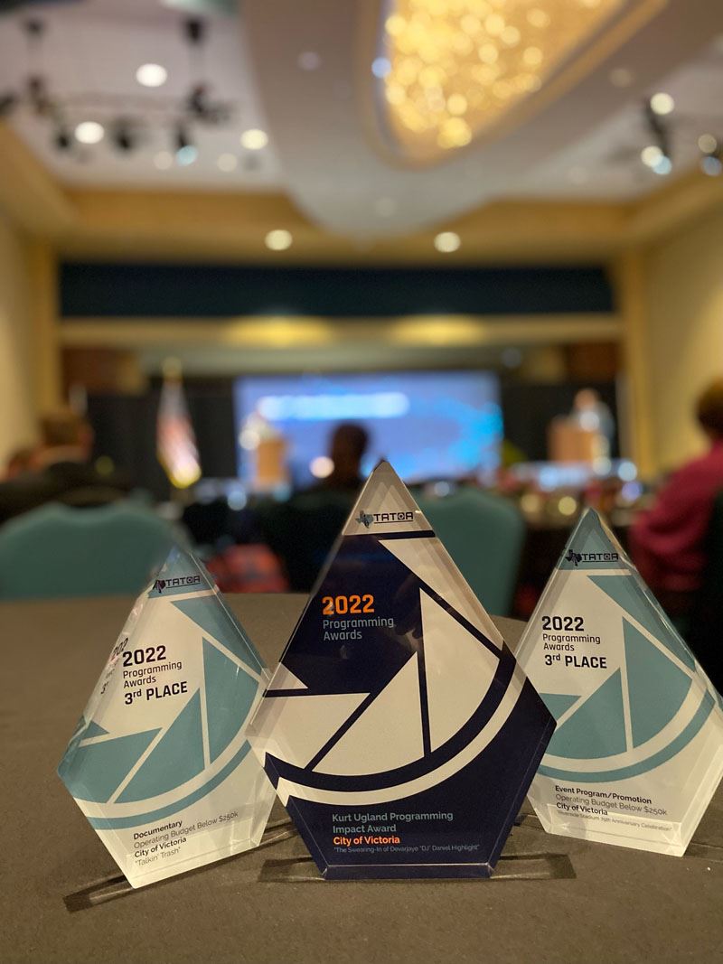 Three glass trophies that read 2022 Programming Awards with more small text