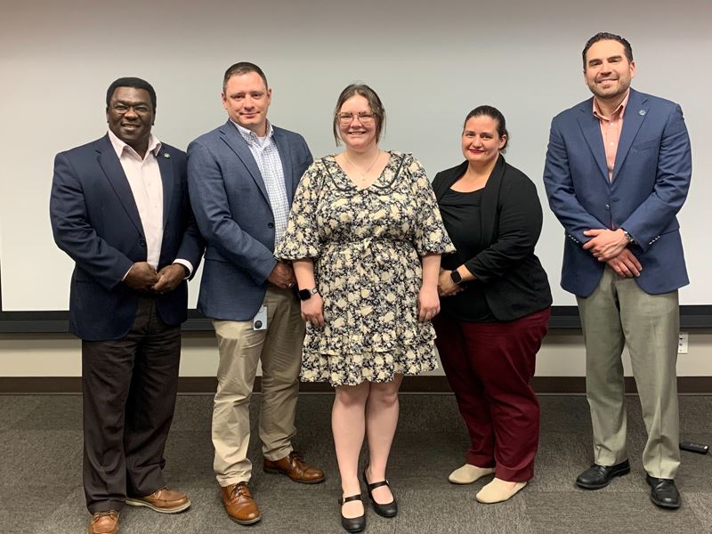 Group photo in upstairs conference room at 700 Main Center