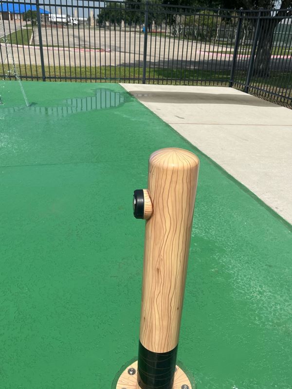A child-height rubber pole shaped like a baseball bat with a button on it.