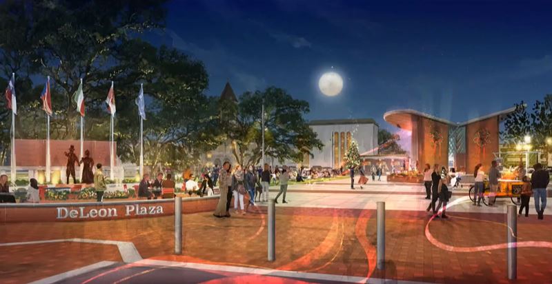 DeLeon Plaza with a large stage and a Christmas tree. Wreaths hang on the outside of the stage.