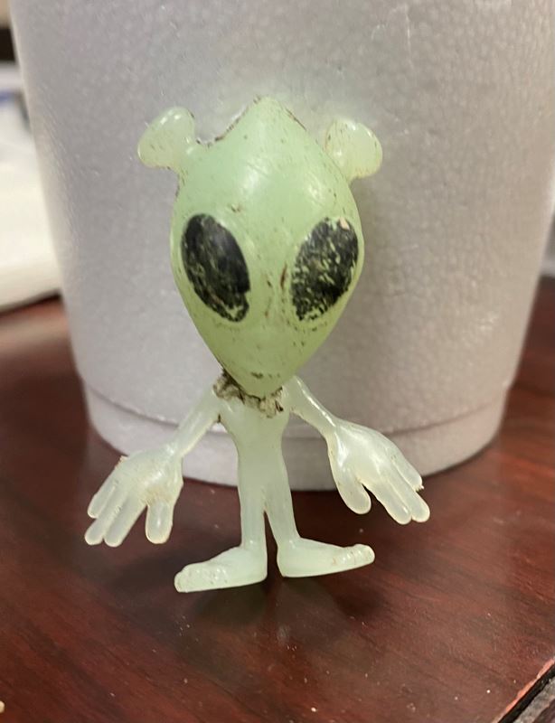 A small alien made of green rubber