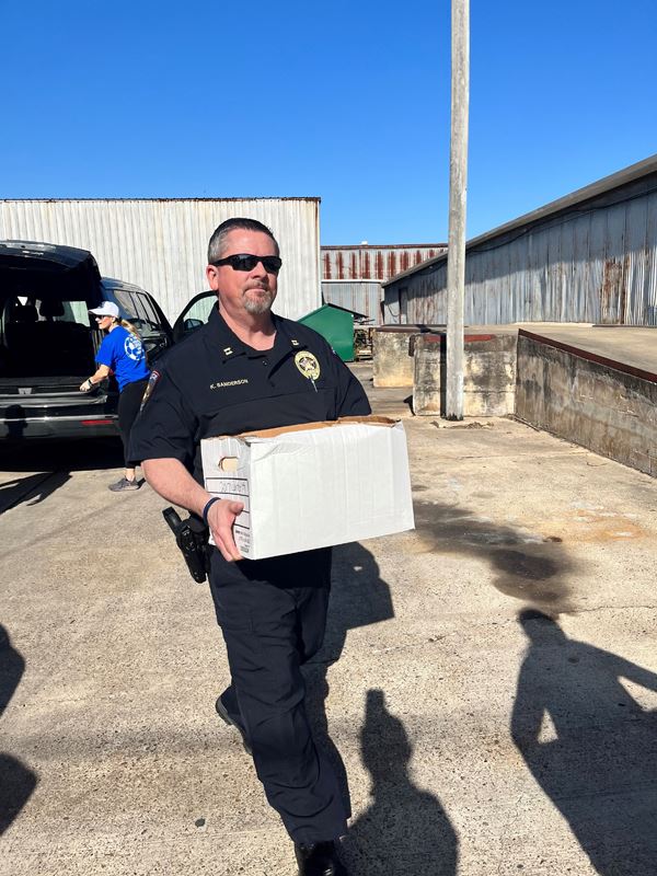 A man carrying a white box.