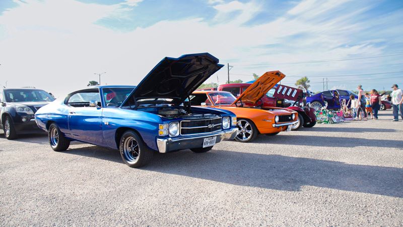 Colorful custom cars in a parking lot at a car show