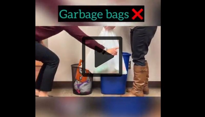 A hand lowers a trash bag into a recycling bin. Another hand shakes a finger no. Play button visible