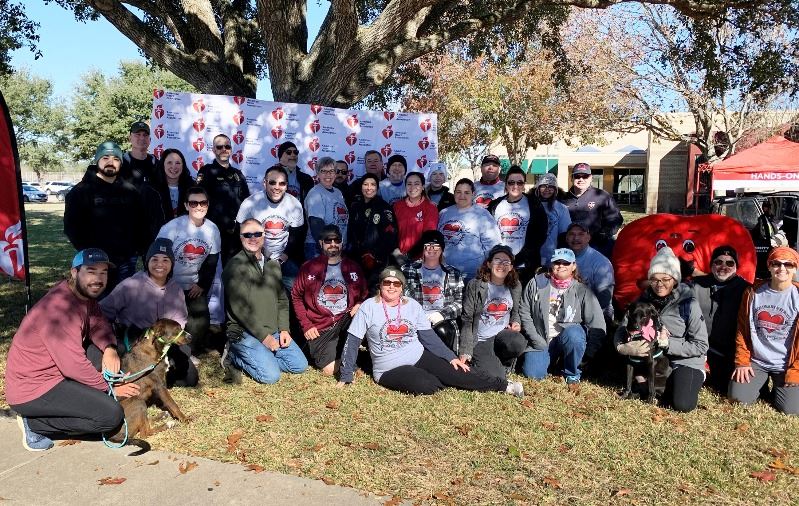 Group photo outdoors in front of American Heart Association backdrop